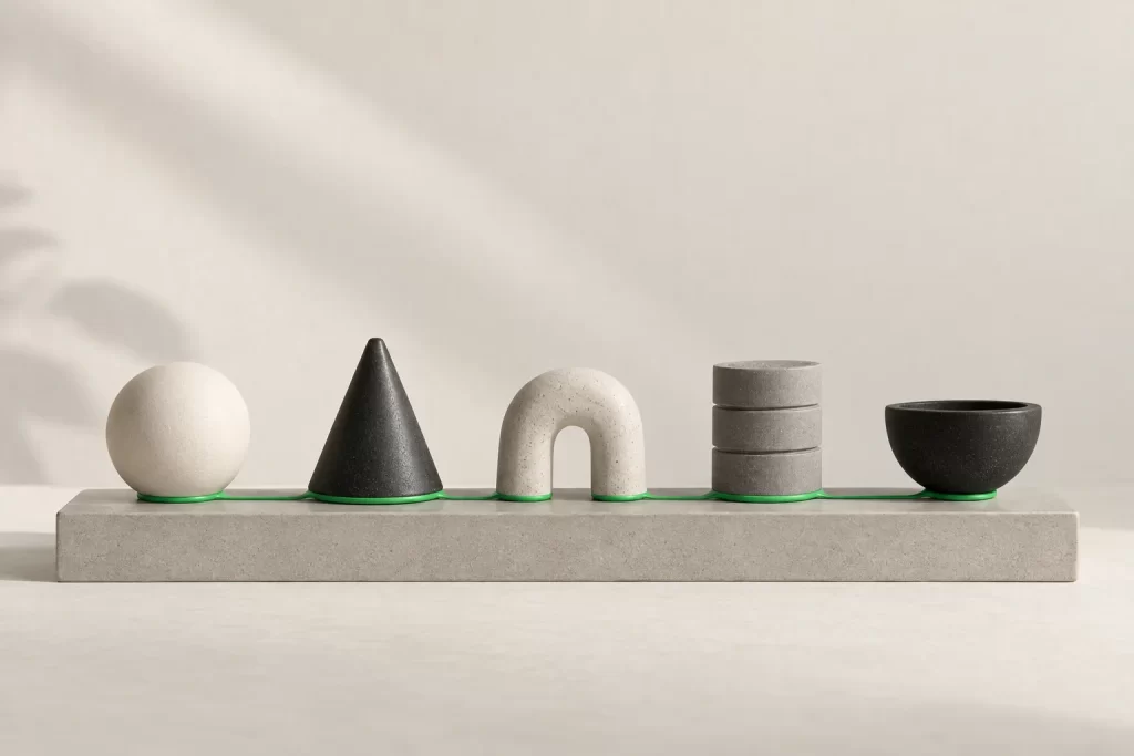 Five different ceramic objects in a row joined at the base by one green line