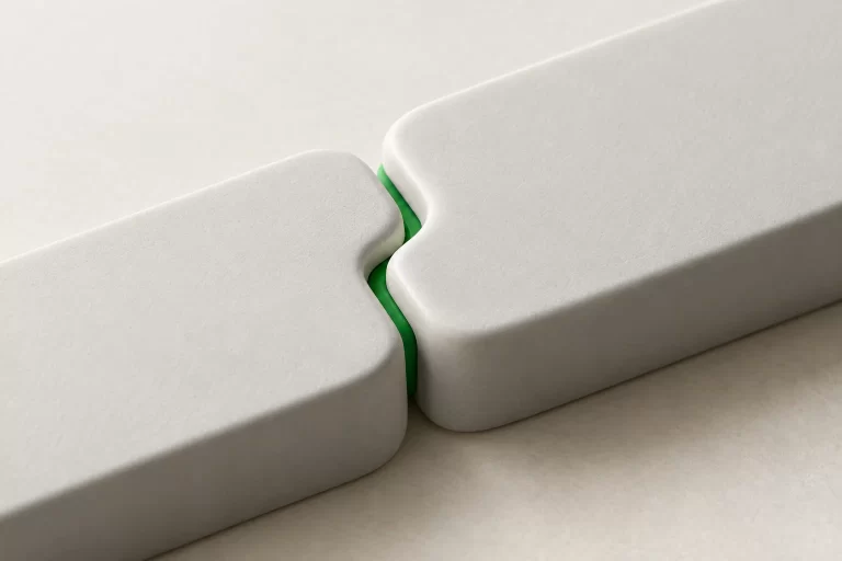 Two white modules locking together along a green seam